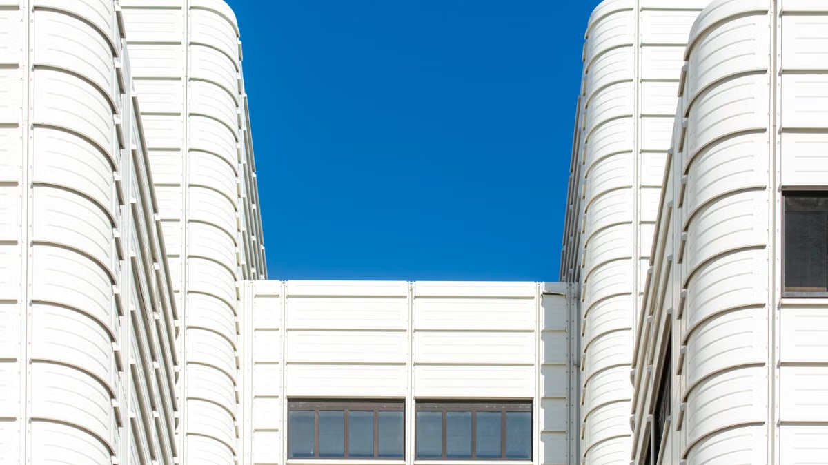 White modern building facade with clear blue sky in Den Haag, Netherlands.